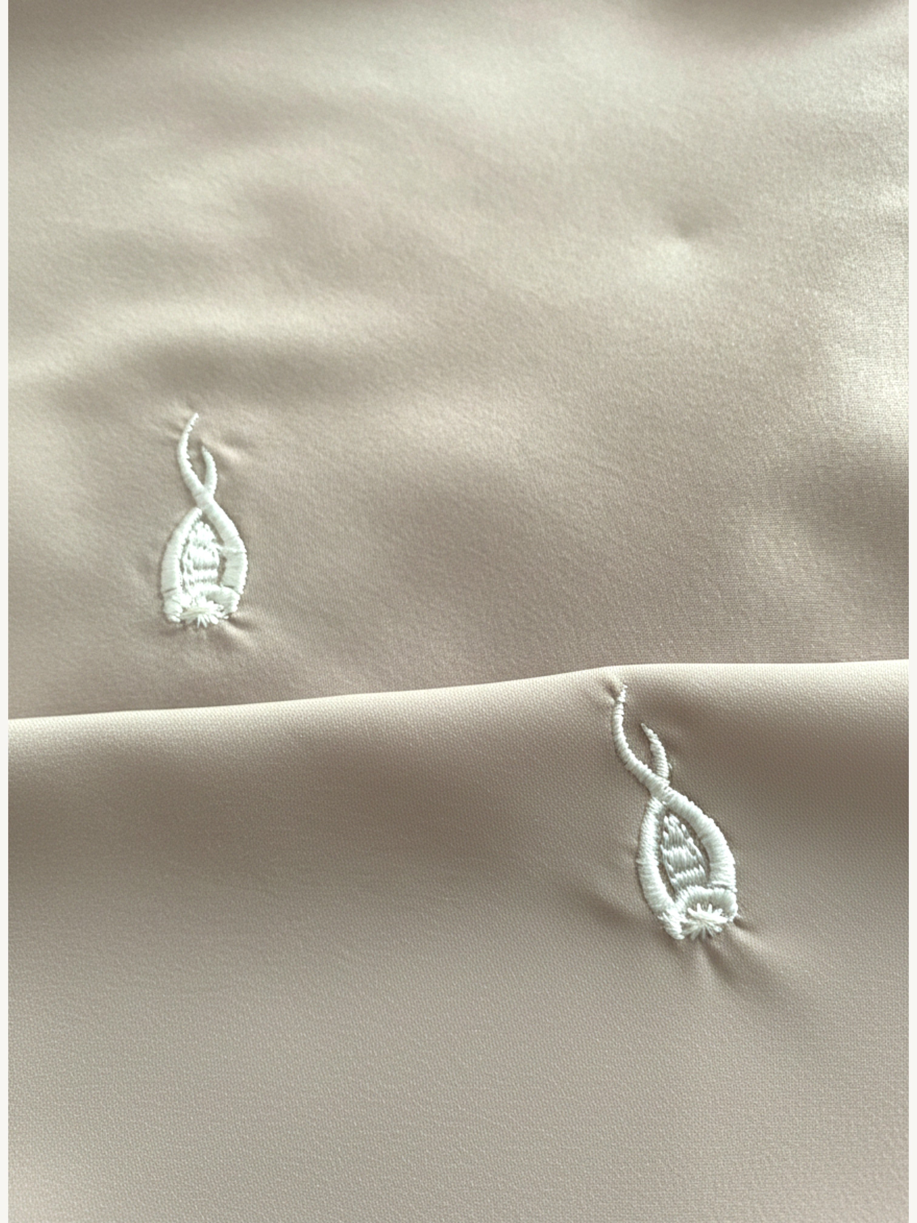 Beige hijab with repeated tulip embroidery in lightweight polyester fabric